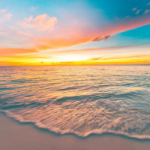 majestic-closeup-view-of-calm-sea-water-waves-with-orange-sunrise-sunset-sunlight-tropical-island-beach-landscape-exotic-shore-coast-summer-vacation-holiday-amazing-nature-scenic-relax-paradise-photo-1.webp